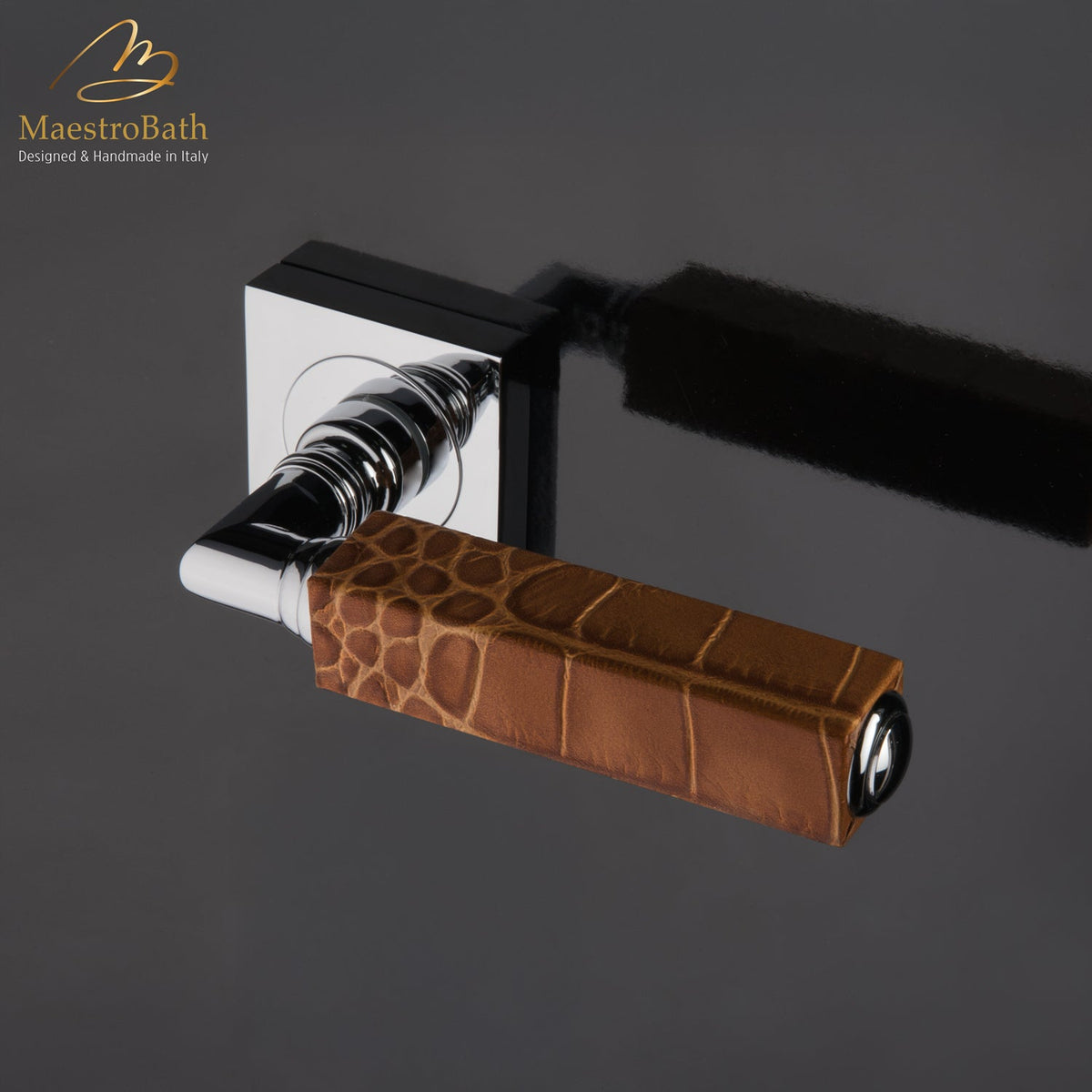 Brass and leather door handle, shown in caramel and chrome, 5.3 inch by 1.9 inch by 2.9 inch